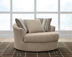 Oversized beige accent chair with rounded arms and two striped back cushions.