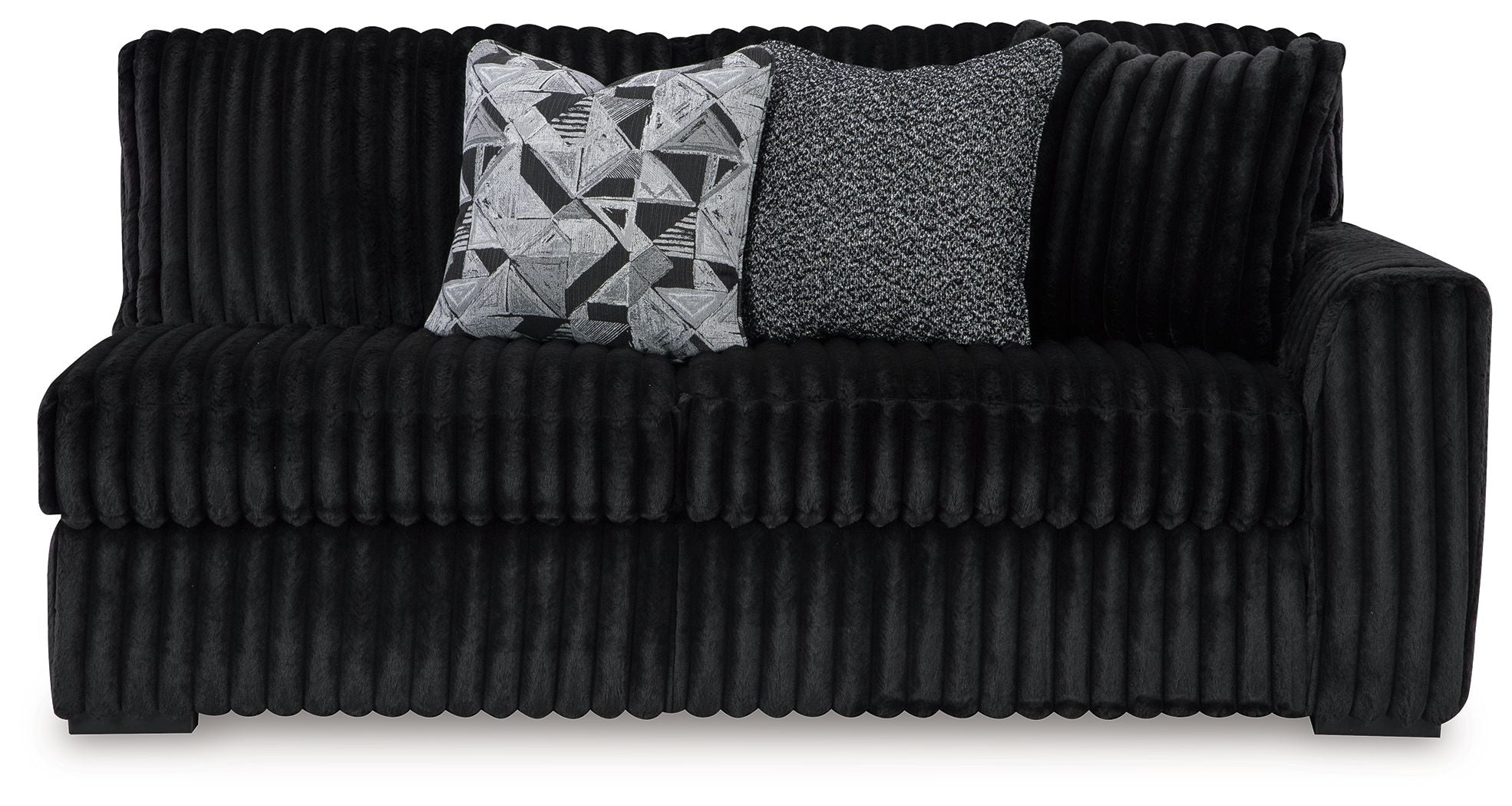 Dark velvet sofa with tufted front, rounded arms, and two throw cushions