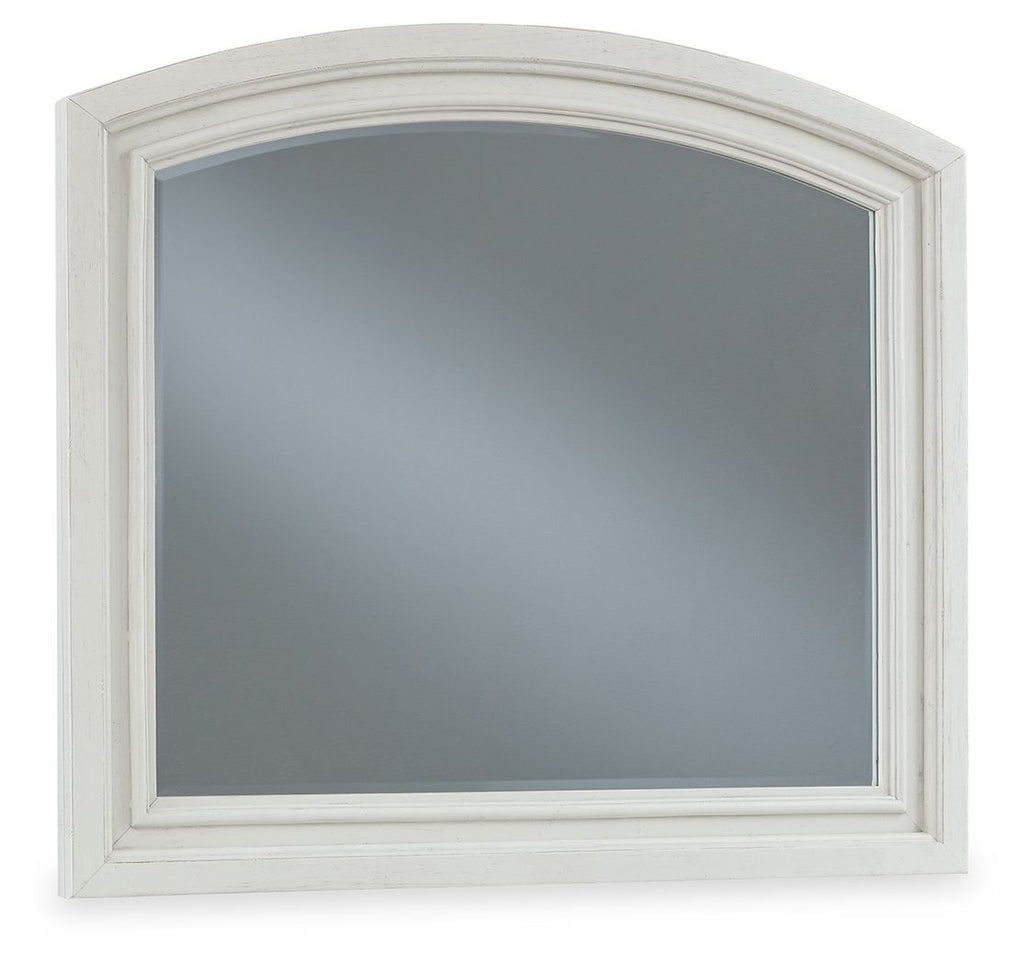 Arched antique white mirror with inset glass and pale trim border.