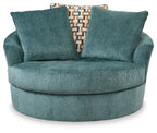 Teal fabric swivel accent chair with rounded arms and two back cushions