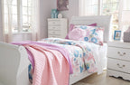 White sleigh bed headboard with curved posts and floral quilted bedding