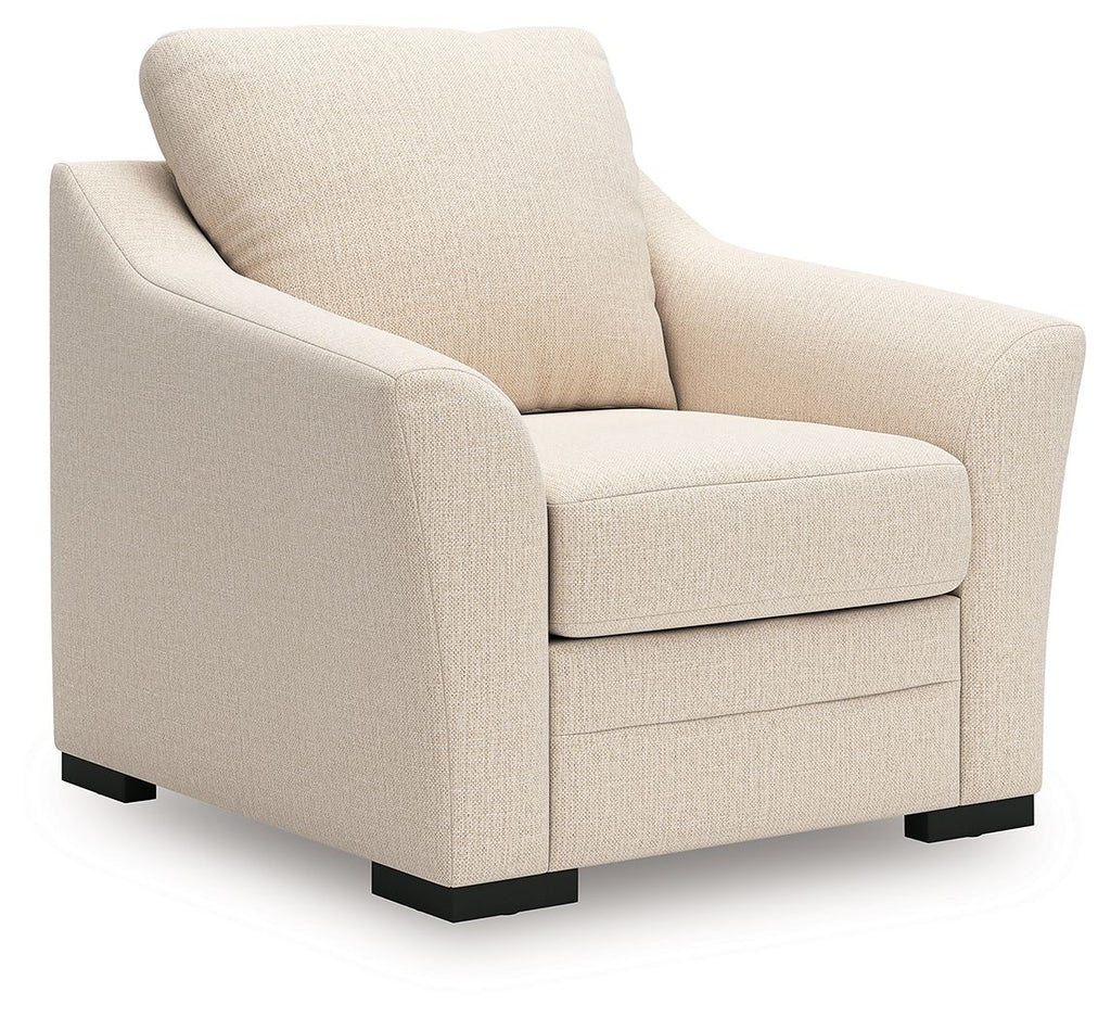 Beige upholstered lounge chair with tall back, track arms, and black feet