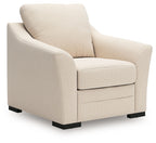 Beige upholstered lounge chair with tall back, track arms, and black feet