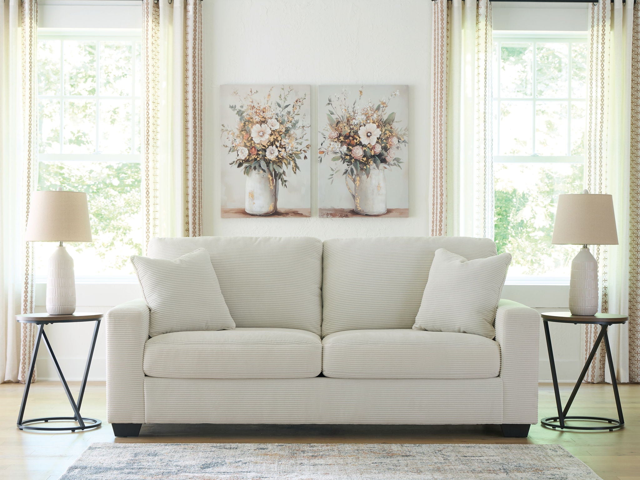 Greenbriar sofa in white fabric, three back cushions, four throw pillows, dark legs