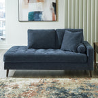 Blue fabric corner chaise with tufted seat and rounded bolster pillow