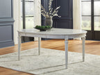 Antique white oval extension dining table with straight skirt and turned legs