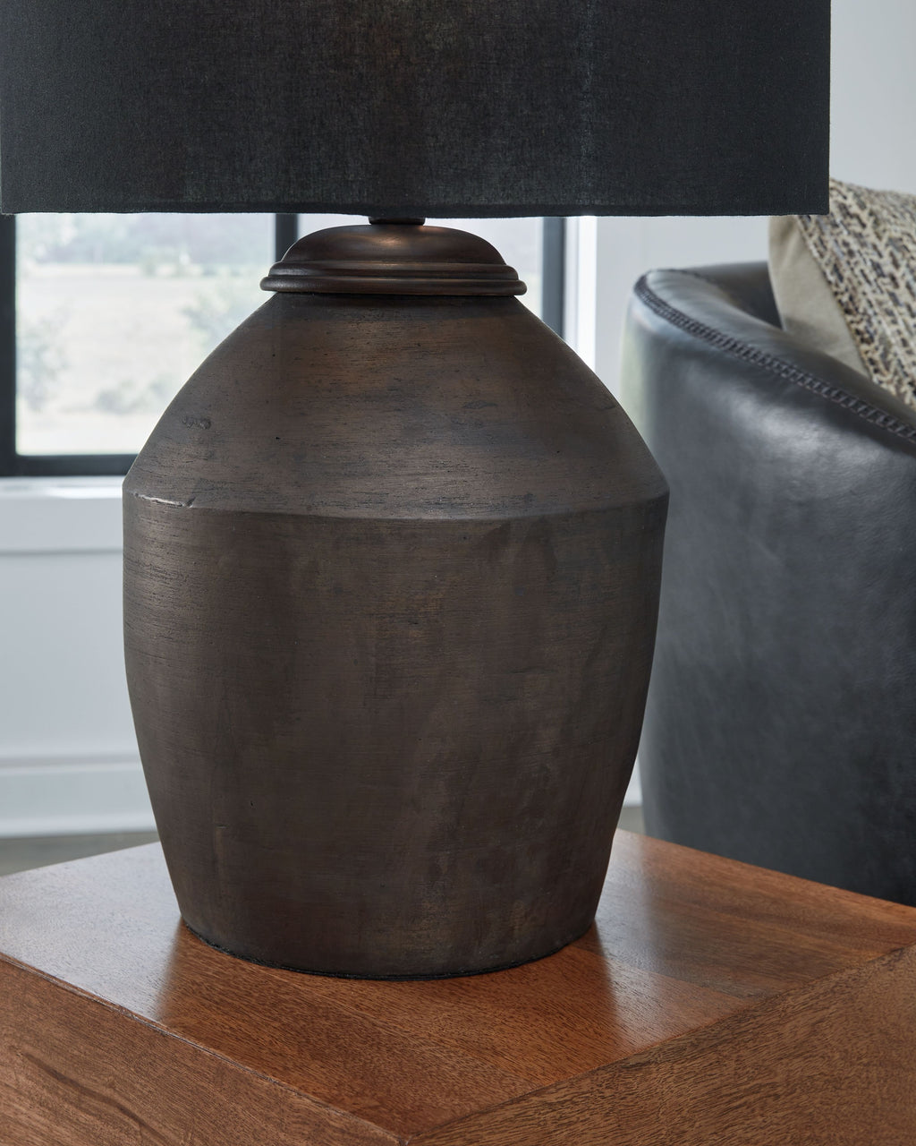 Table lamp with black fabric shade and rounded dark bronze base