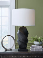 Black poly table lamp with white drum shade and sculpted textured base