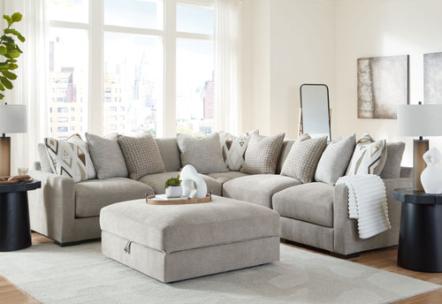 Gray sectional sofa set with chaise corner and patterned throw pillows, includes ottoman