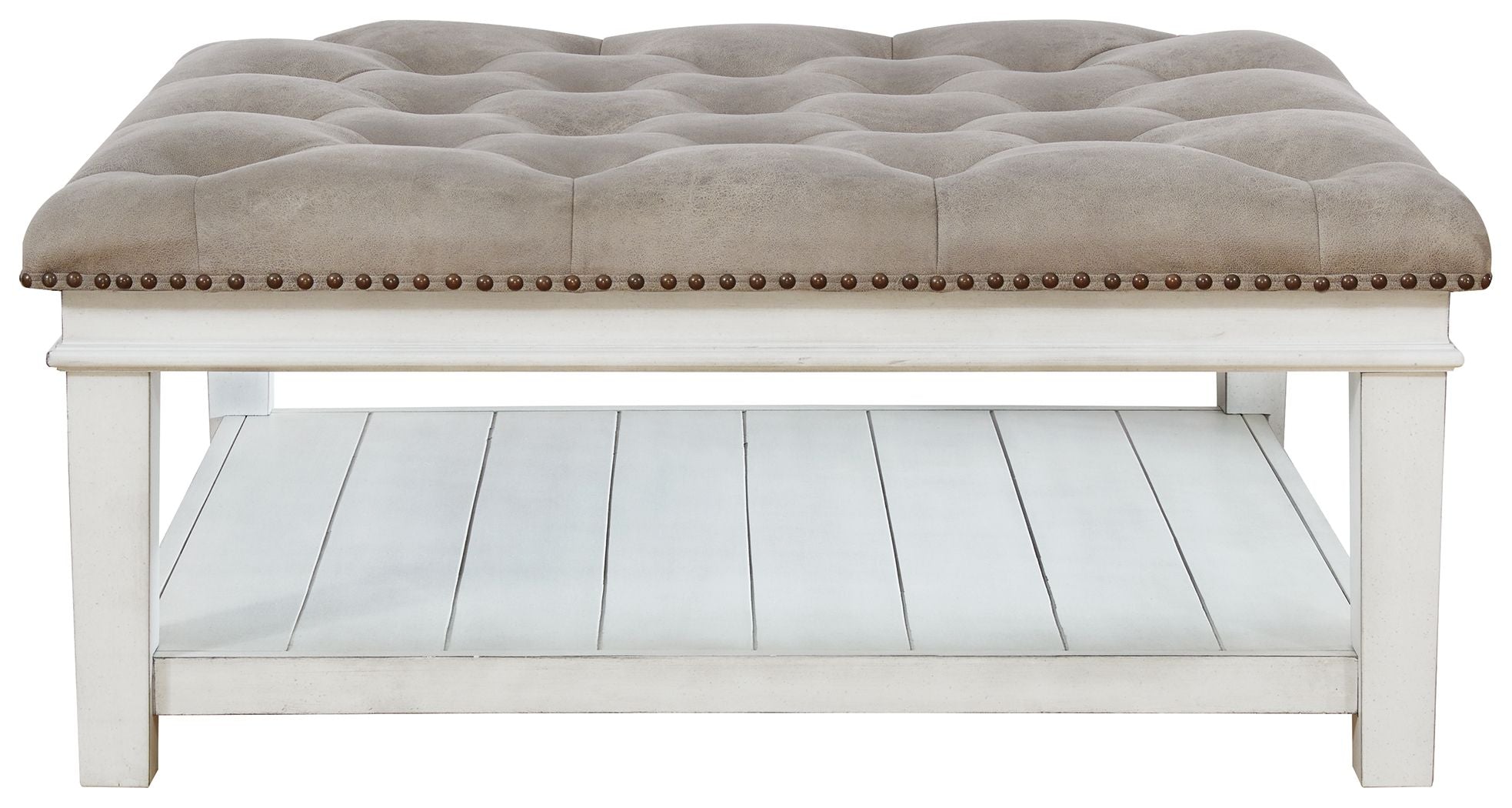 Upholstered ottoman cocktail table with tufted top, nailhead trim, open shelf