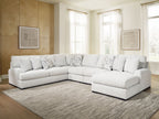 Light beige sectional sofa with chaise corner and patterned throw pillows on arms