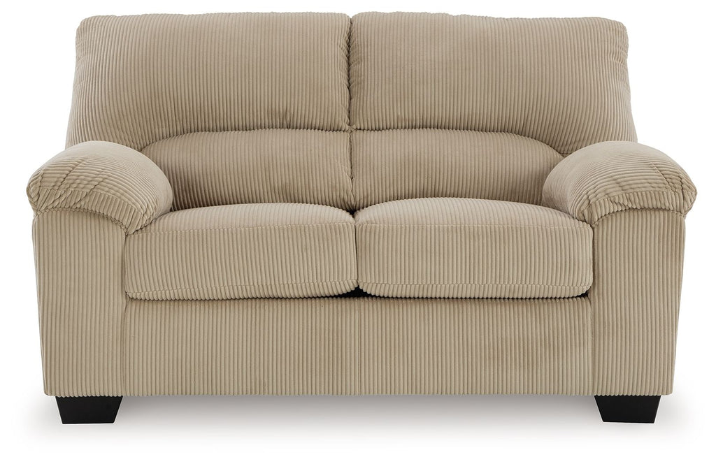 Beige corduroy loveseat with rolled arms, tufted back, and cushioned two-seat panel