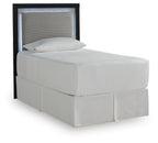 Light gray upholstered panel headboard with dark side frame and textured inset.