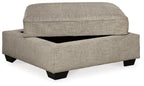 Stone beige upholstered storage ottoman with hinged lid and black legs