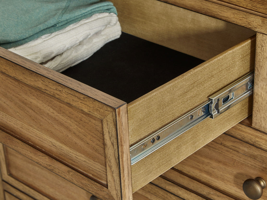 Light brown dresser drawer with metal glides and open compartment