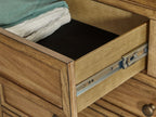 Light brown dresser drawer with metal glides and open compartment