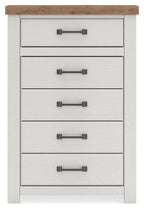 White five-drawer chest with brown top and dark metal bar pulls