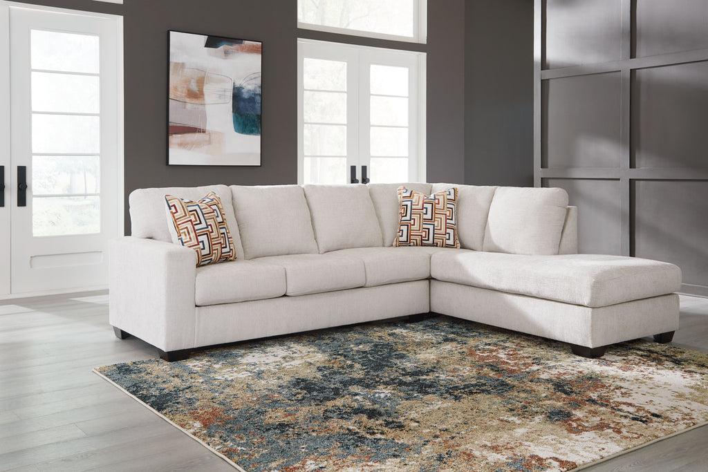 Light stone fabric sectional sofa with corner chaise and patterned accent pillows