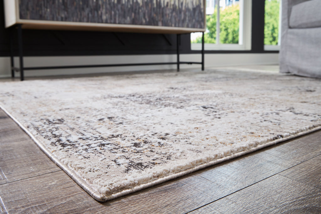 Dark gray distressed area rug with abstract pattern and bound edges