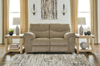 Reclining loveseat in beige fabric with plush arms and two back cushions