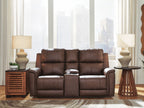 Power reclining loveseat with console, dark brown upholstery in a living room setting