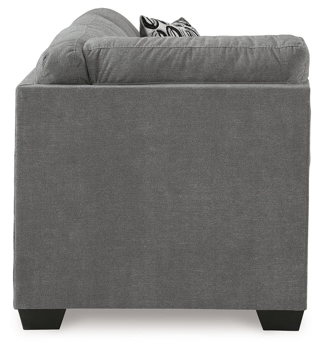 Gray fabric corner sofa with square arms, dark legs, and patterned cushions on top