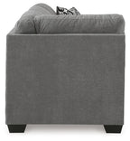 Gray fabric corner sofa with square arms, dark legs, and patterned cushions on top