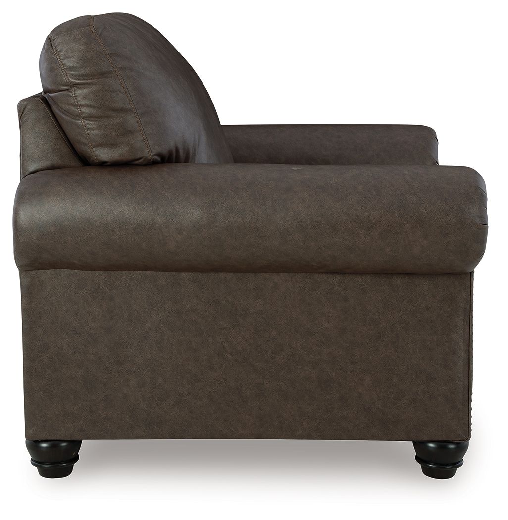 Roxmere chair side view in dark umber fabric with rolled back and nailhead trim