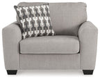 Gray flannel chair and a half with patterned square throw pillow and rounded arms