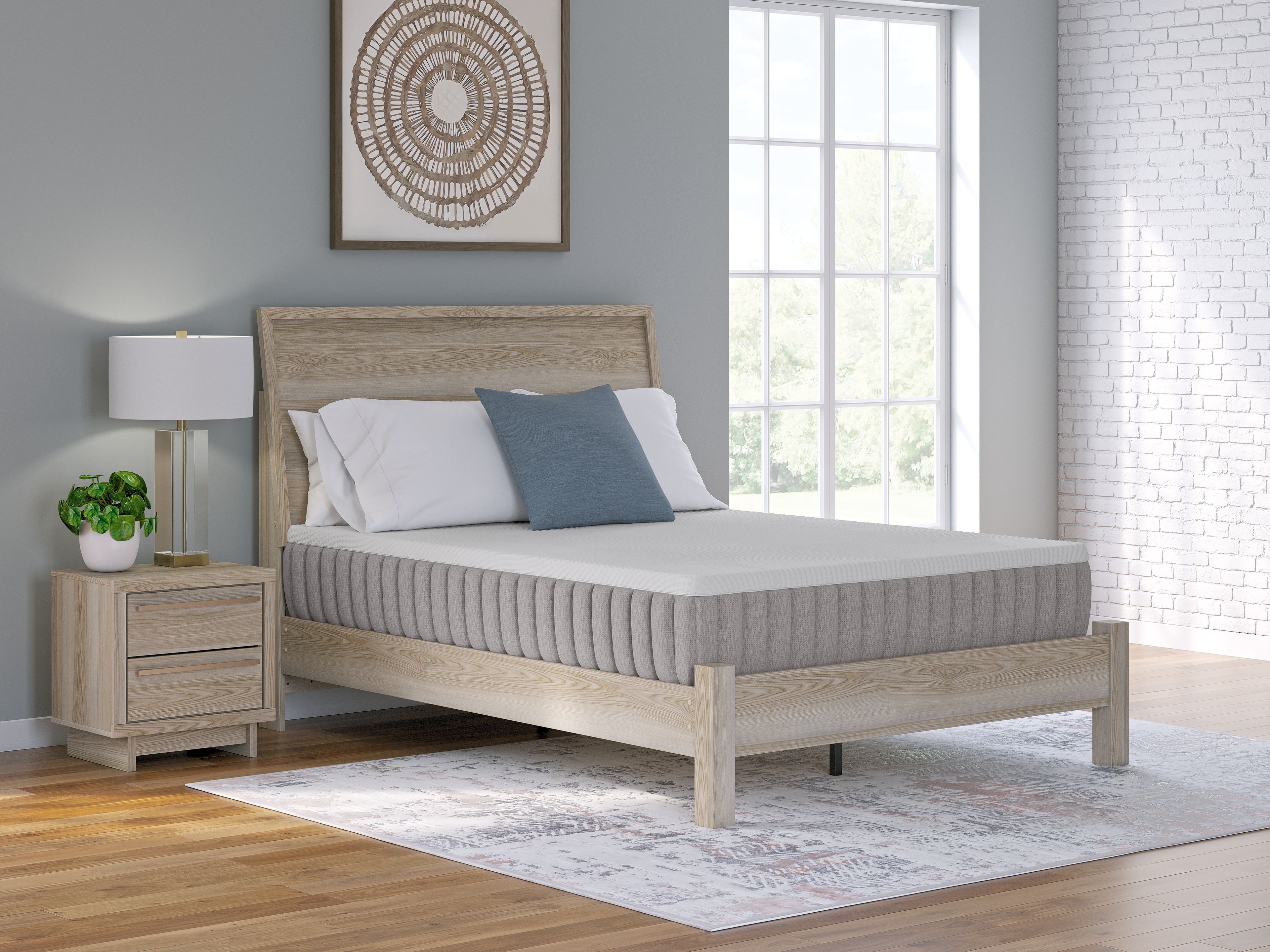Firm mattress with white cover and gray sides on wooden bed frame