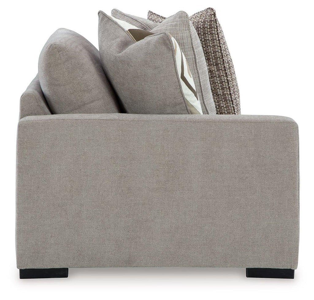 Pebble gray corner chair front with boxy arms and short black legs