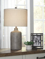 Ceramic table lamp with off-white fabric shade and textured dark ceramic base