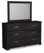 Black dresser with attached mirror and four drawers with silver bar pulls