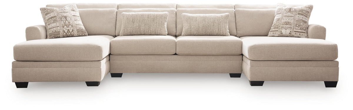 Light beige sectional sofa with chaise and stacked back cushions, patterned throw pillows