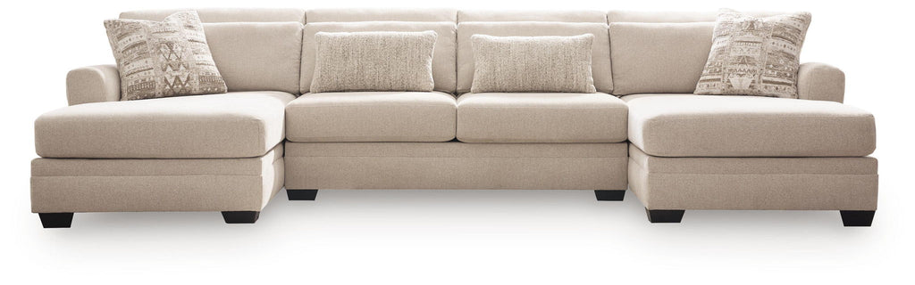 Beige 3-seat sectional sofa with chaise, squared arms, and patterned throw pillows.