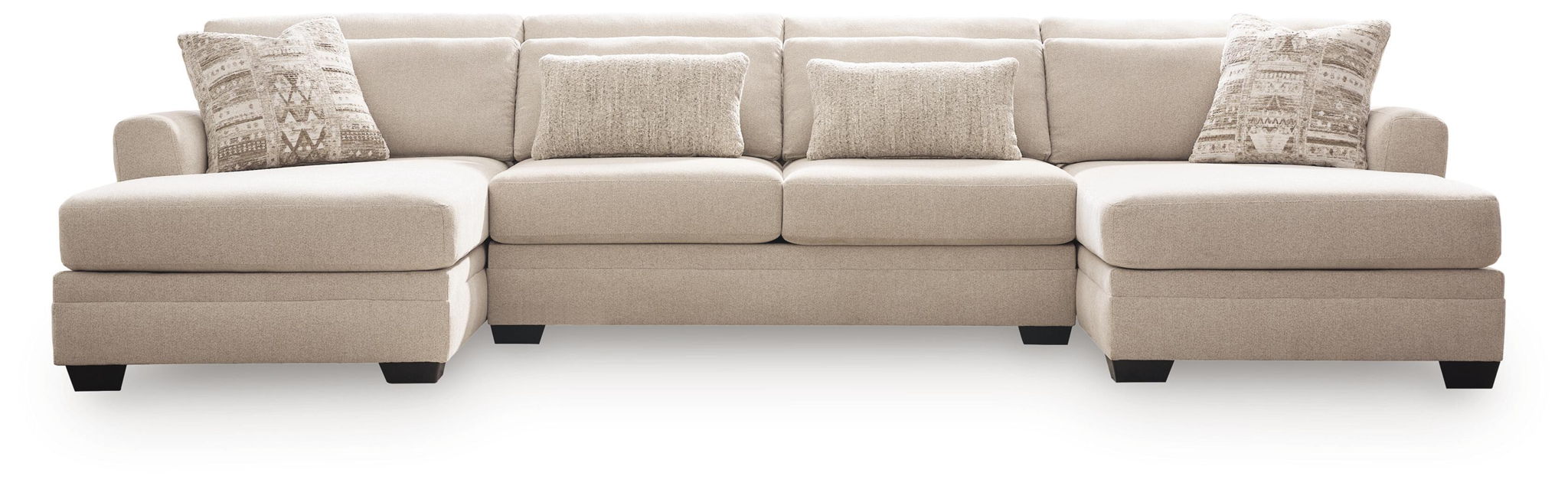 Beige 3-seat sectional sofa with chaise, squared arms, and patterned throw pillows.