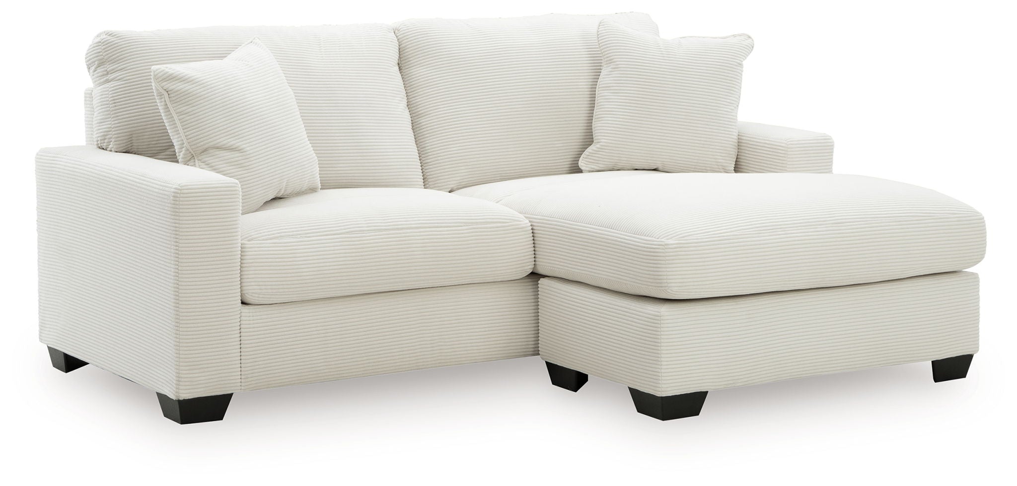 White sofa chaise with four back cushions and a wide chaise ottoman section