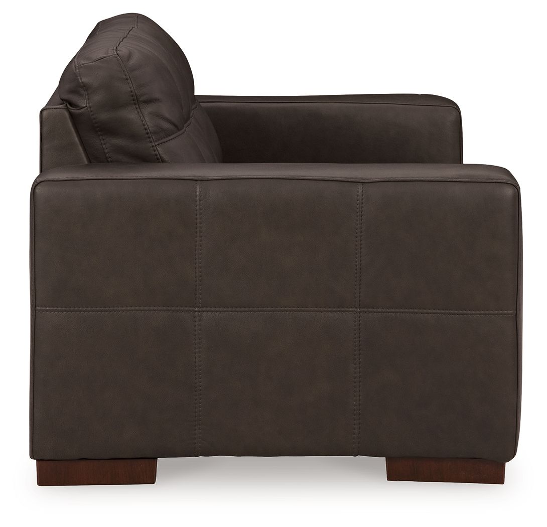 Dark brown loveseat with curved backrest and cushioned seat and arms