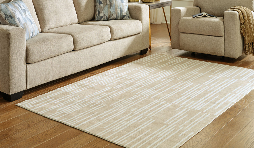 Beige abstract dash patterned area rug with wide flat border
