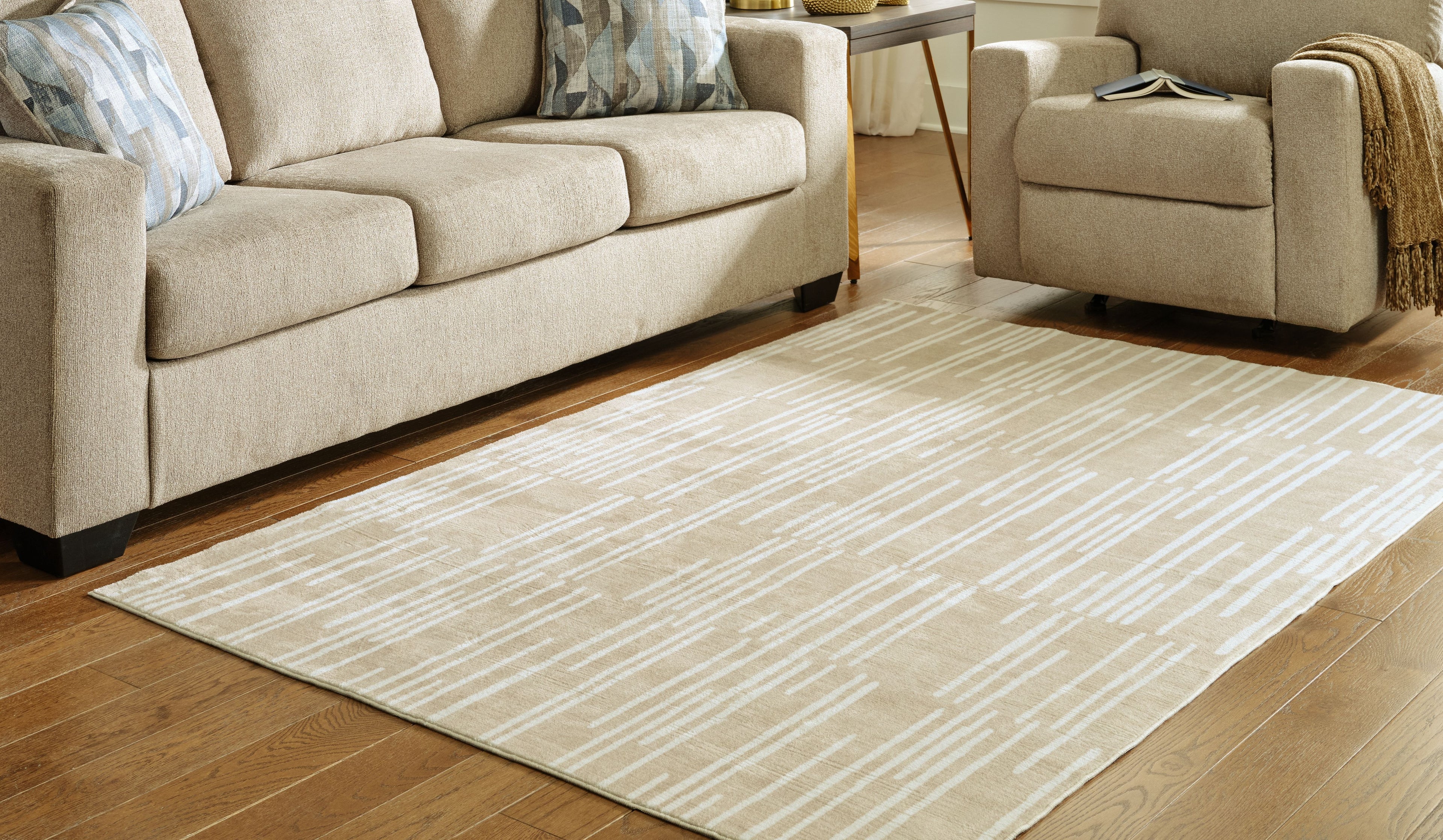 Beige abstract dash patterned area rug with wide flat border