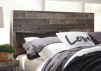 Rustic panel bed headboard with dark wood panels and white bedding with striped pillow