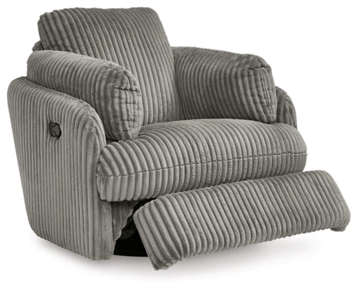 Gray ribbed swivel glider recliner shown with footrest extended and padded headrest.