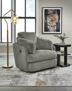 Gray ribbed swivel glider recliner with padded headrest and side arm pocket.