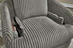 Gray ribbed recliner with armrest console and remote tucked in side pocket.