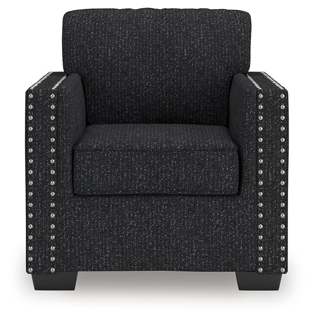 Black textured armchair with nailhead stud trim on the front and sides
