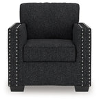 Black textured armchair with nailhead stud trim on the front and sides