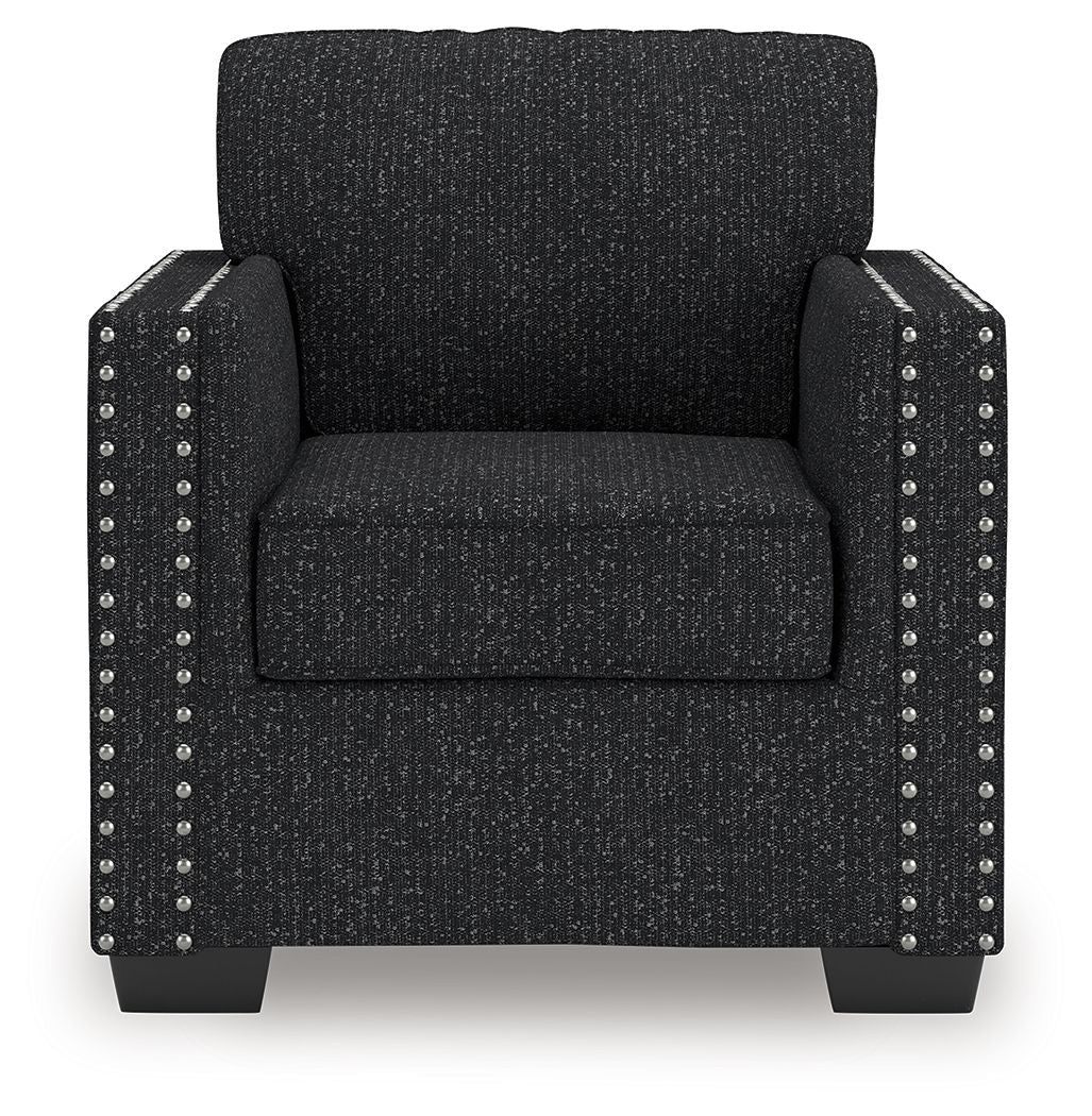 Black textured armchair with nailhead stud trim on the front and sides