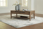Rectangular brown coffee table with drawer and lower shelf; flowers and magazine on top