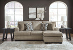 Sectional sofa with chaise in light brown fabric, five pillows with geometric print