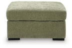 Oversized accent ottoman in textured green upholstery with padded seat cushion and dark legs.